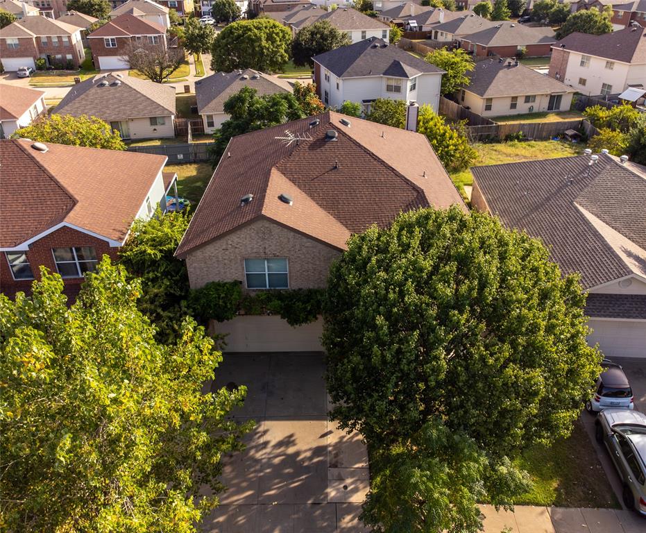 an aerial view of a houses with a yard