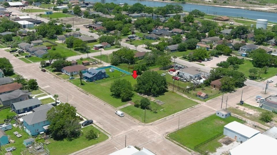 an aerial view of residential houses with outdoor space and street view