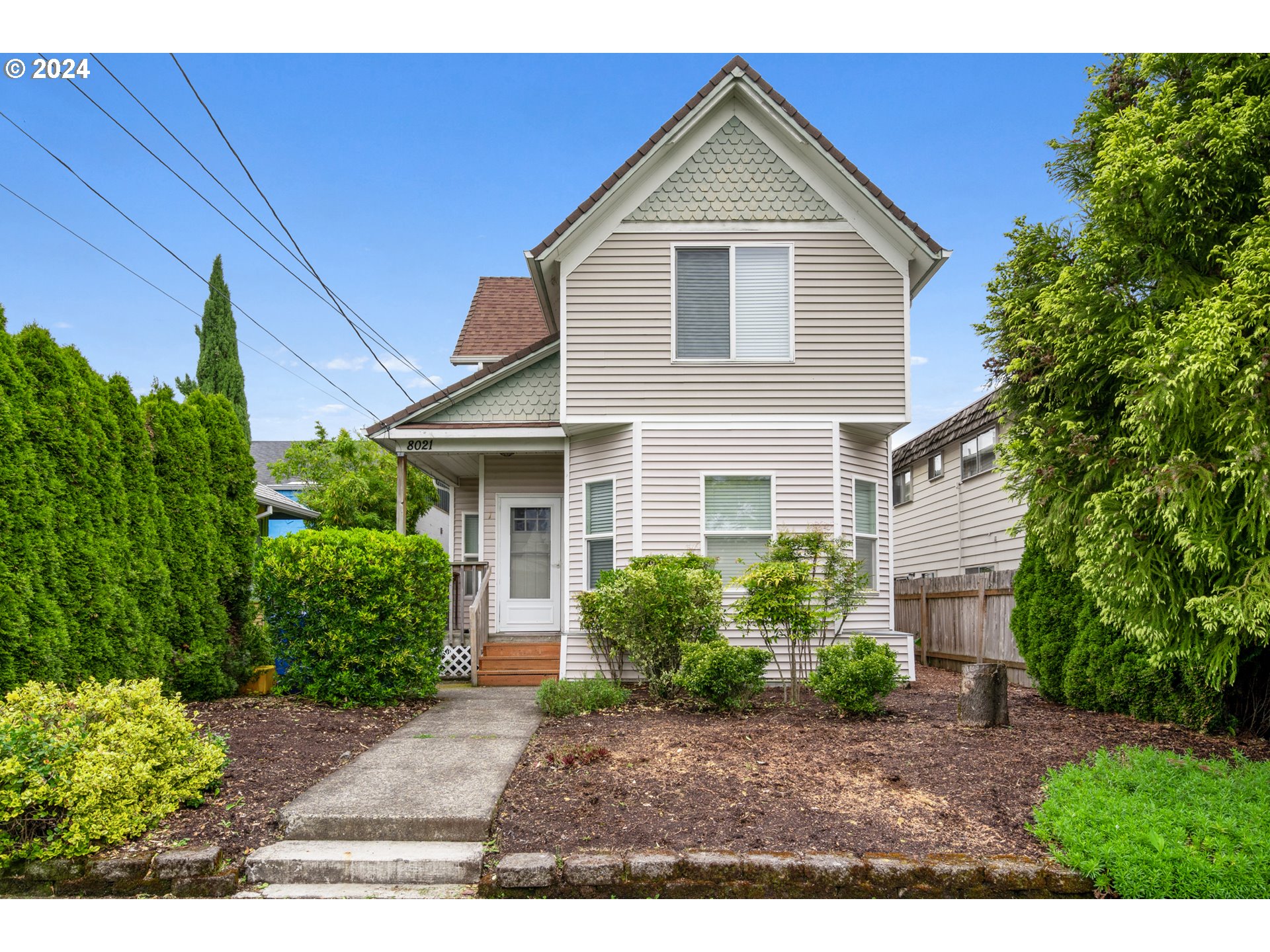 a front view of a house with garden