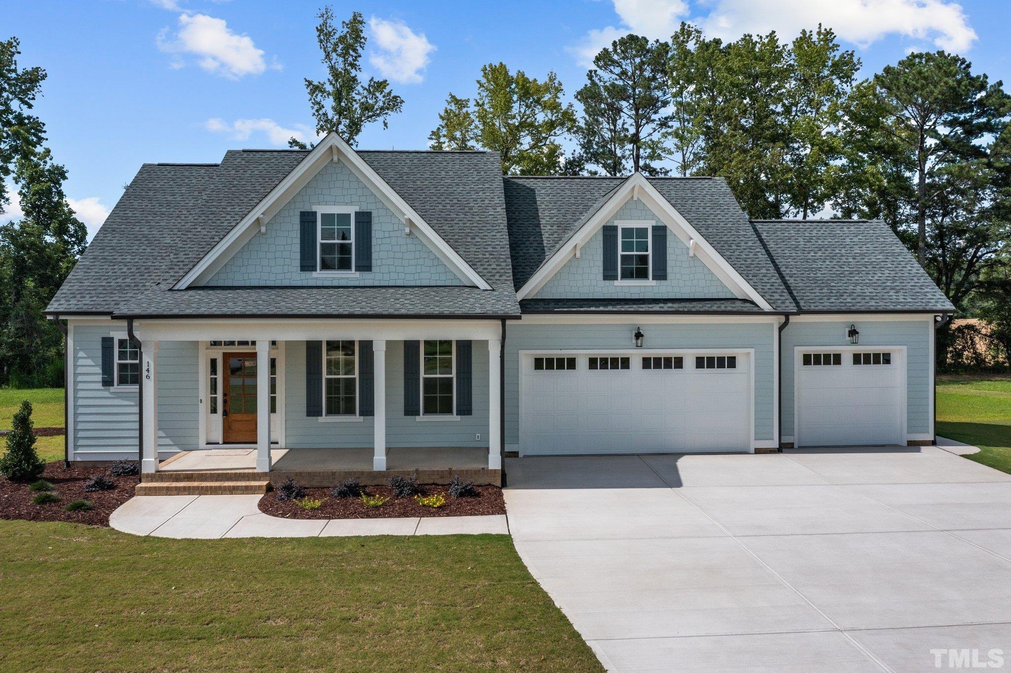 a front view of a house with a yard and porch