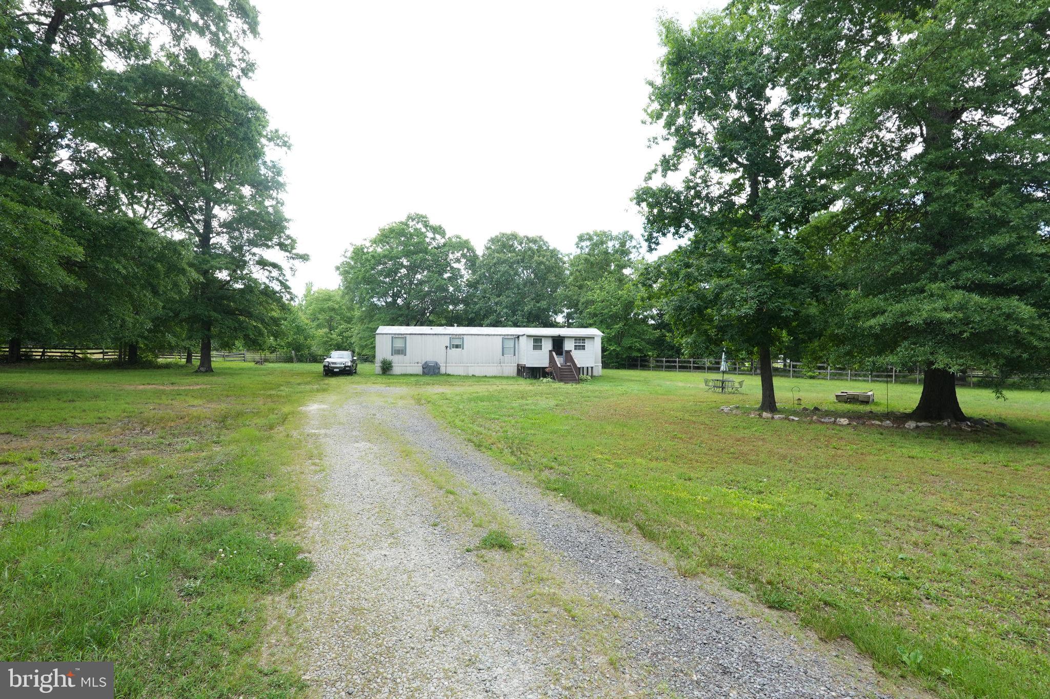 a view of a trees with barn in the background