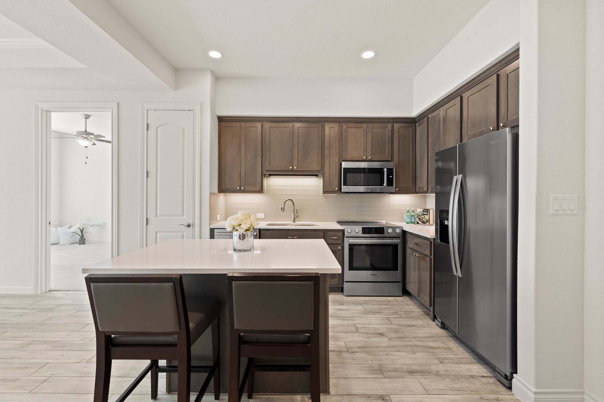 a kitchen with a sink stainless steel appliances and refrigerator