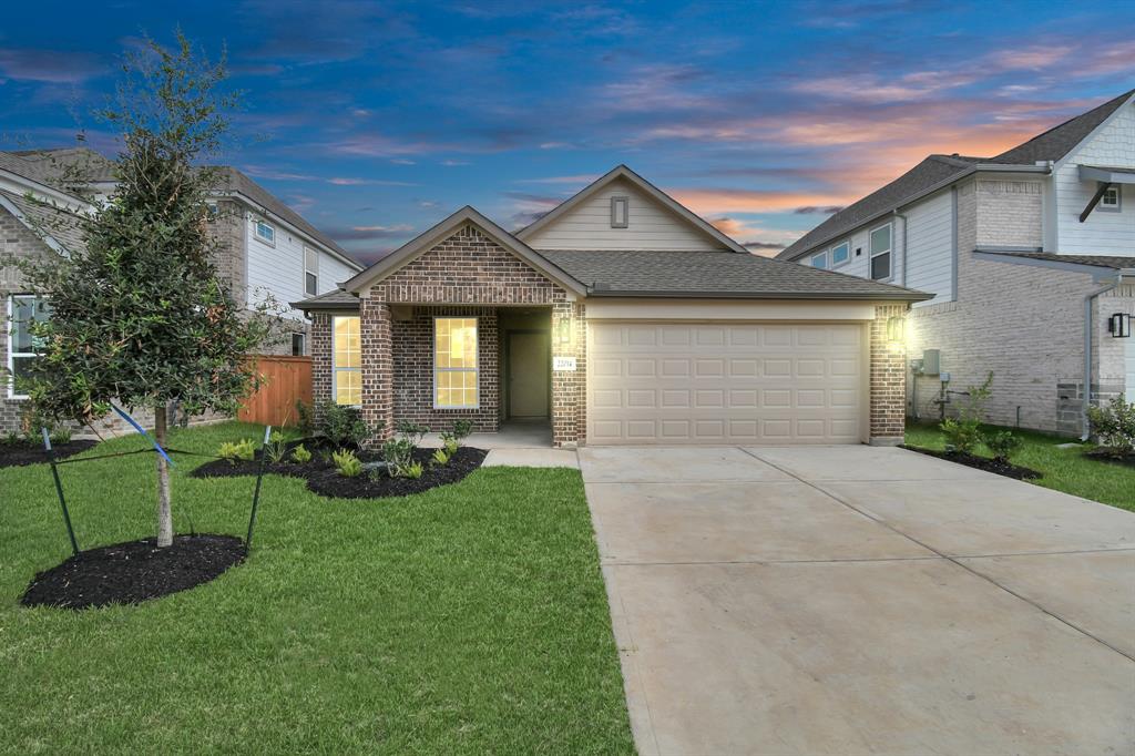 a front view of a house with a yard and garage