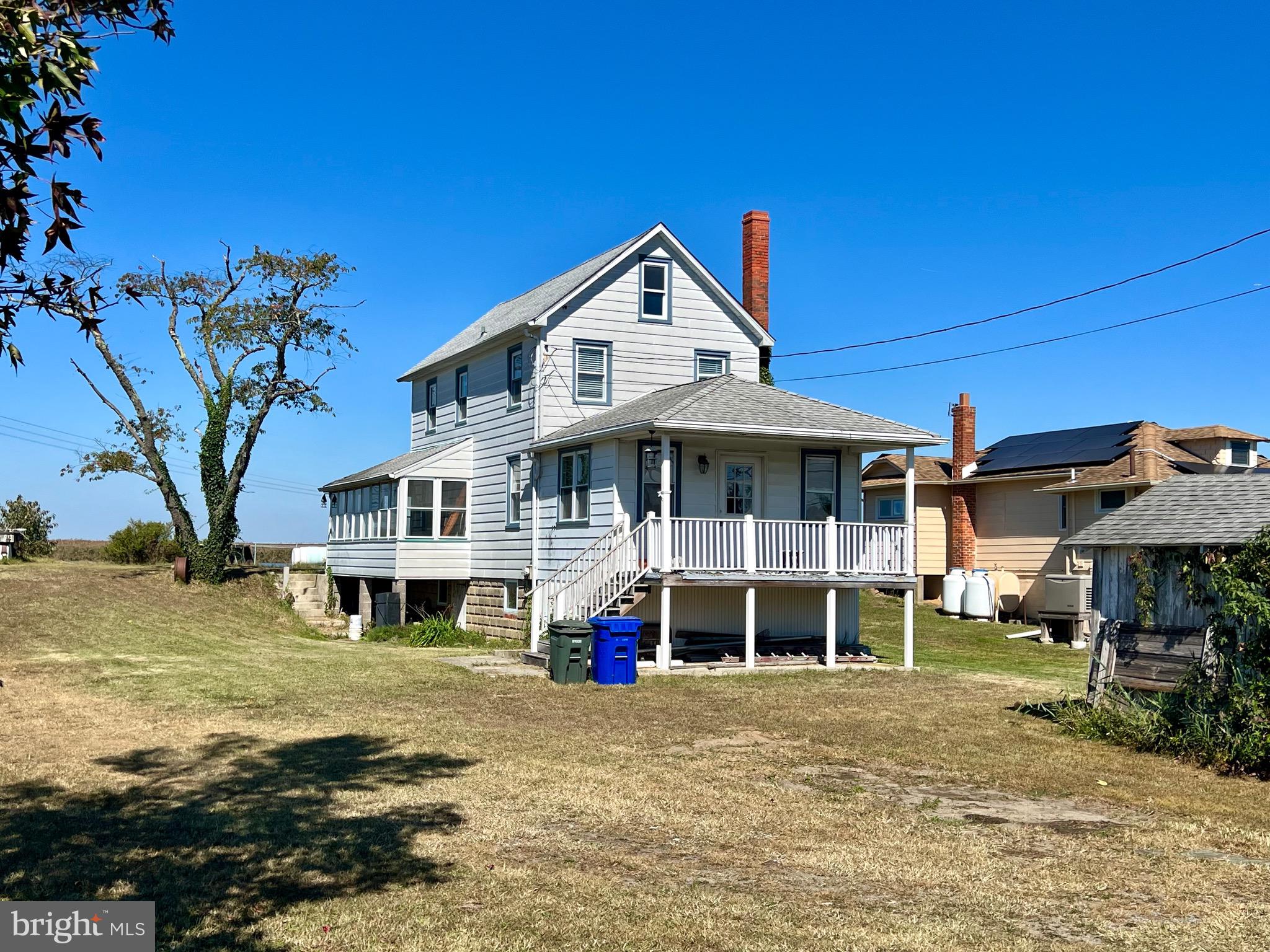 a view of a house with a yard and sitting area