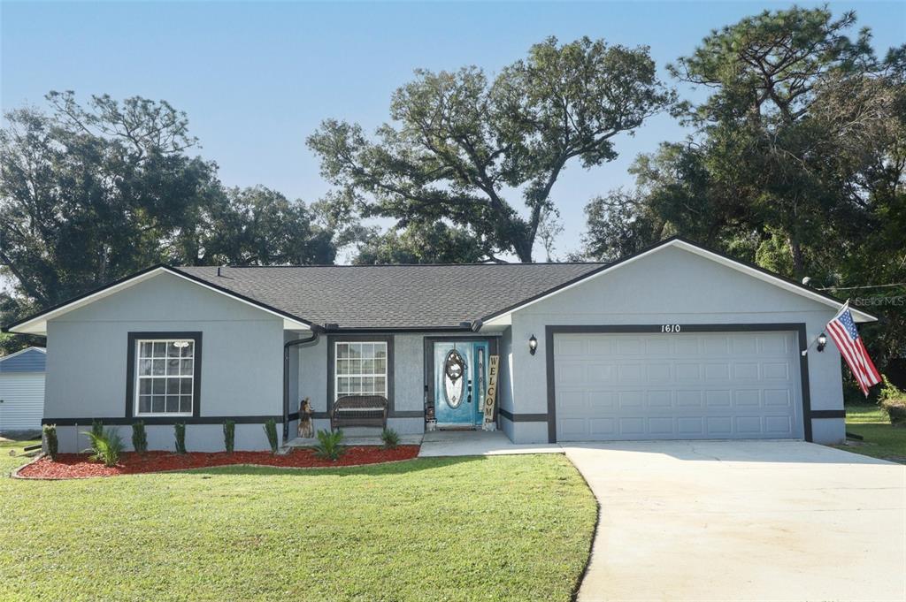 a front view of a house with a yard and garage