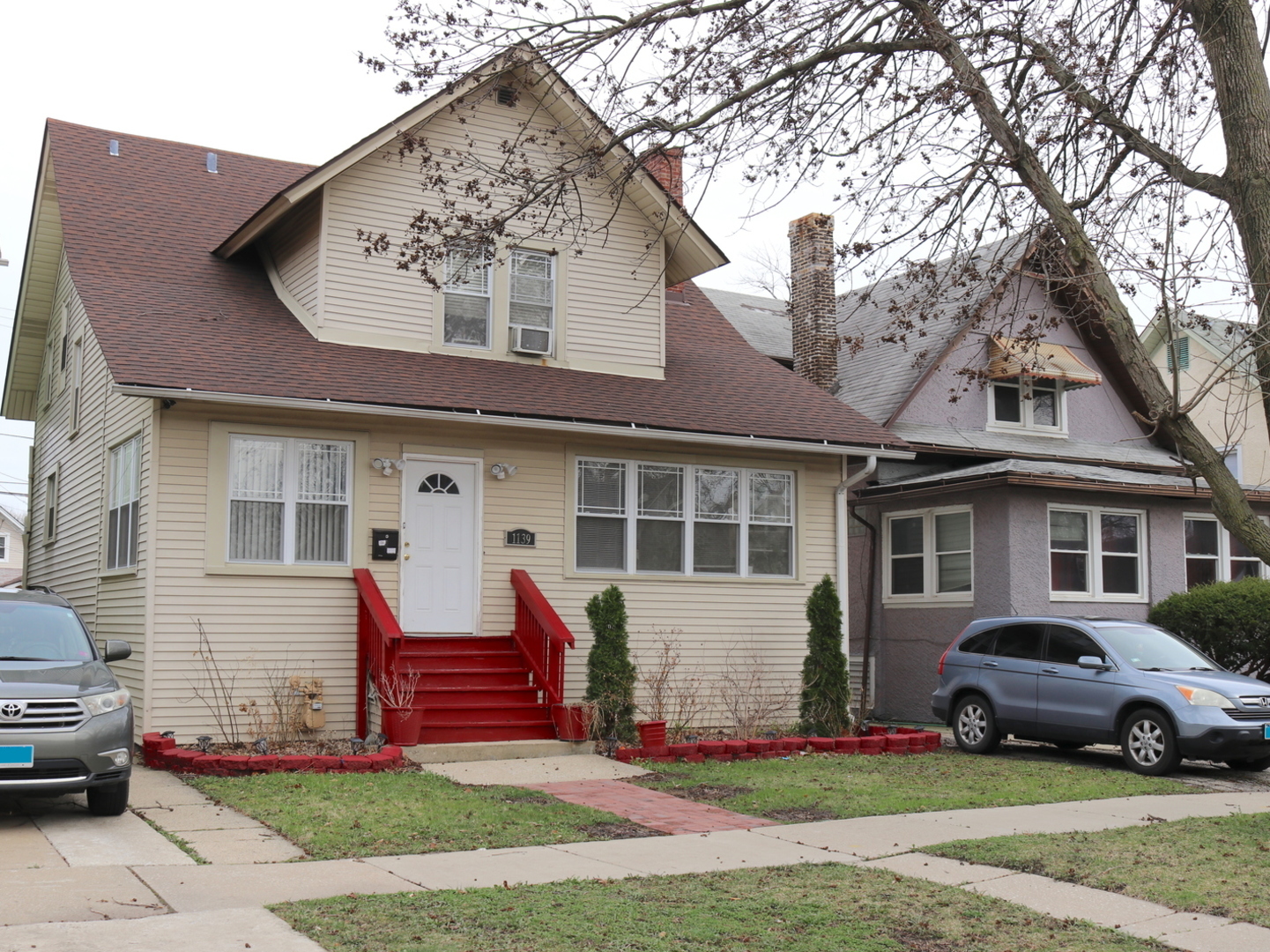 a view of a house with a patio and a yard