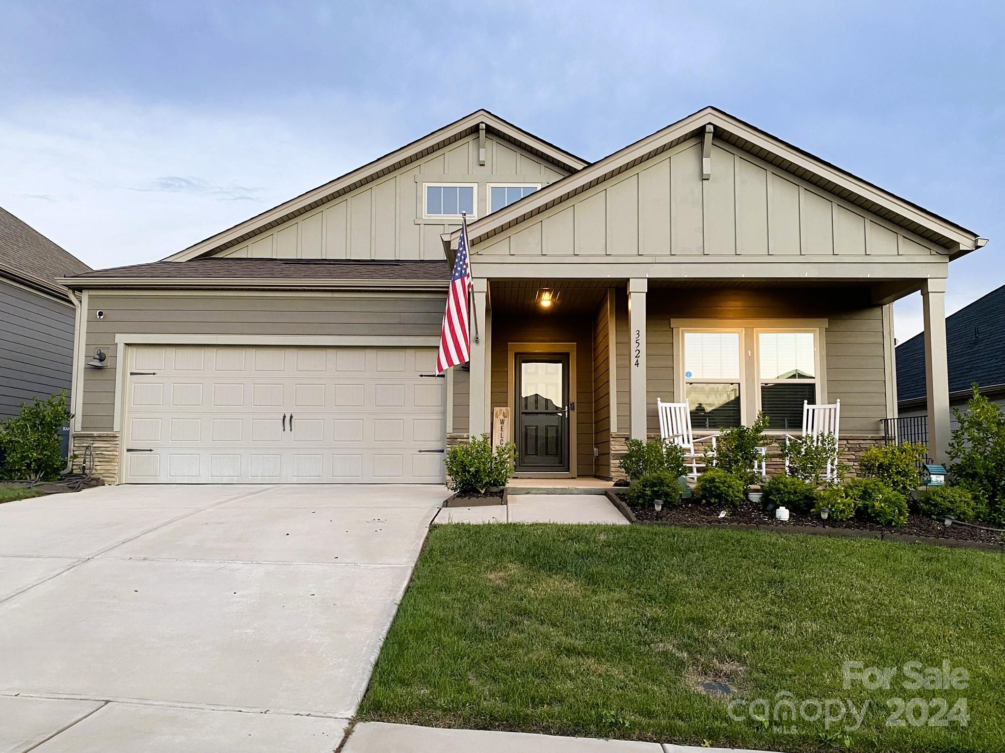 a front view of a house with a yard and porch