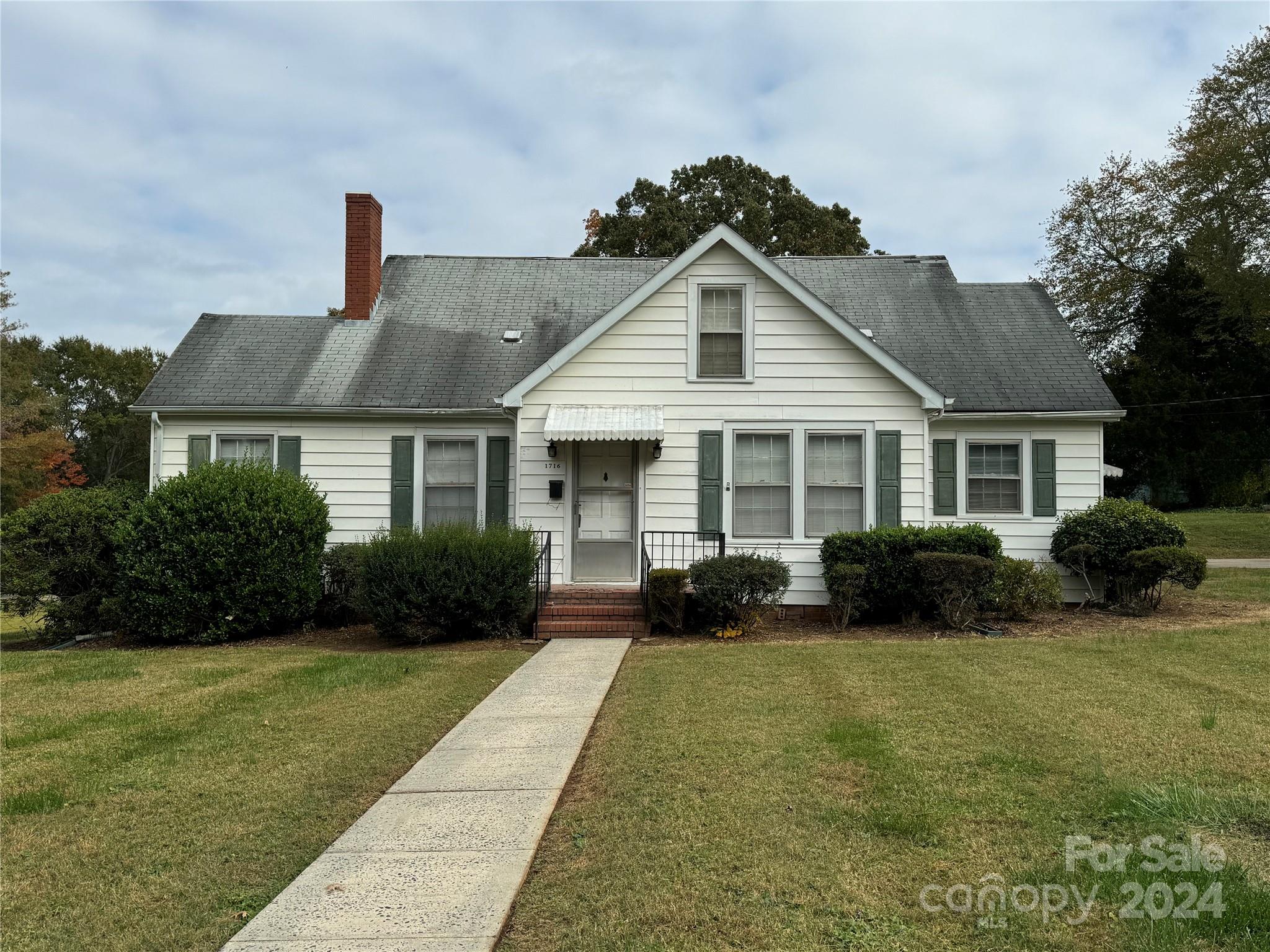 a front view of a house with garden and porch