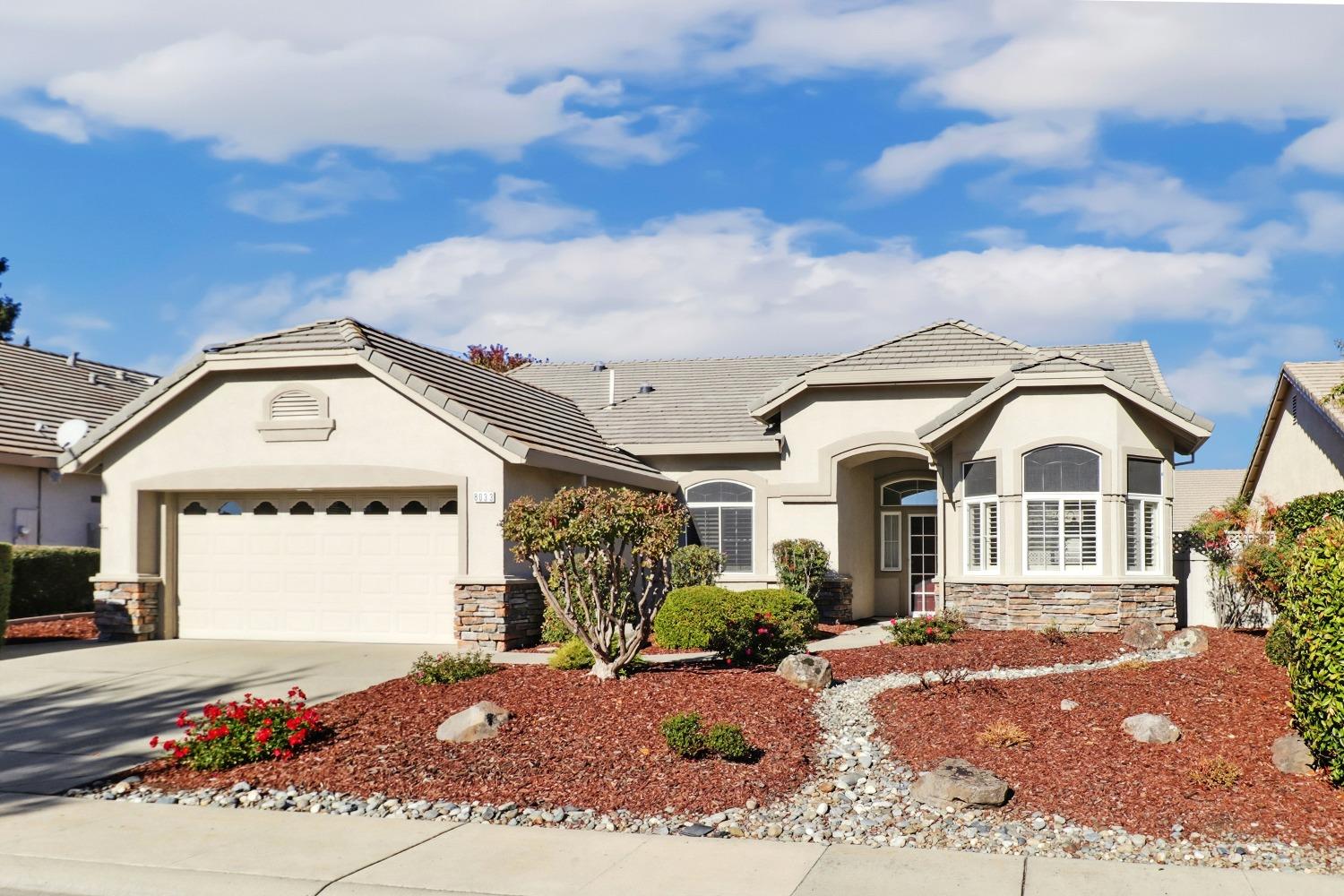 a front view of a house with garden