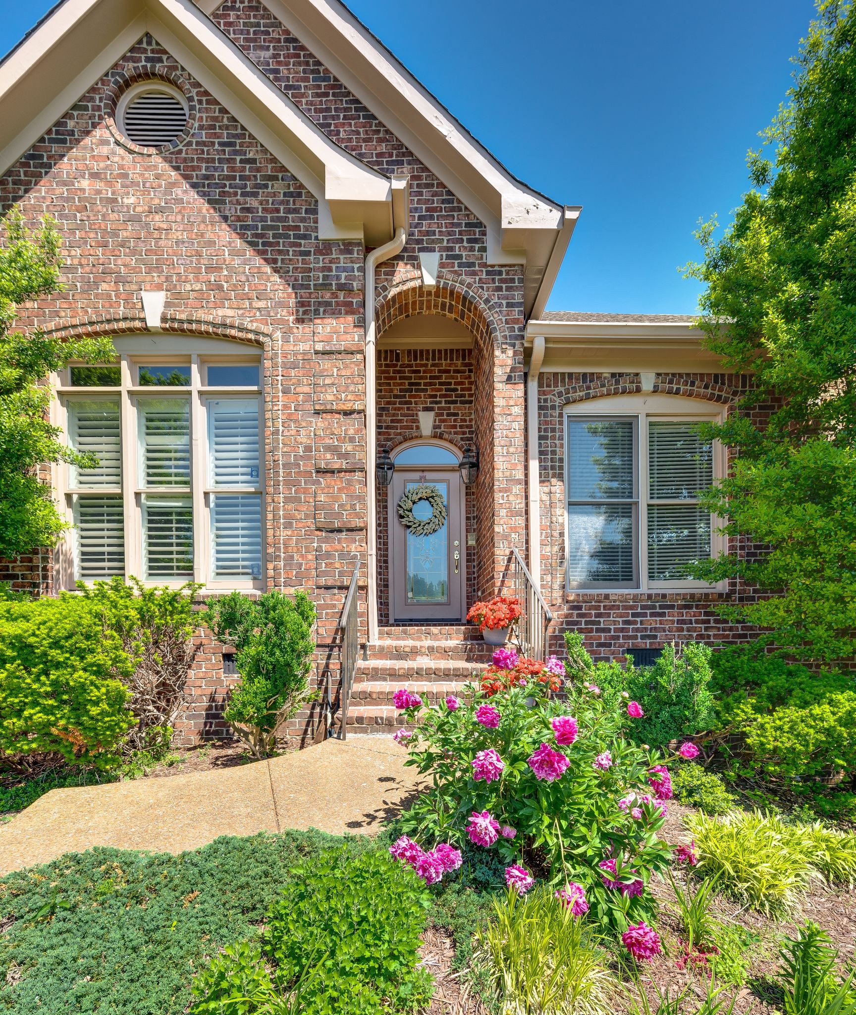 front view of a brick house with a large window