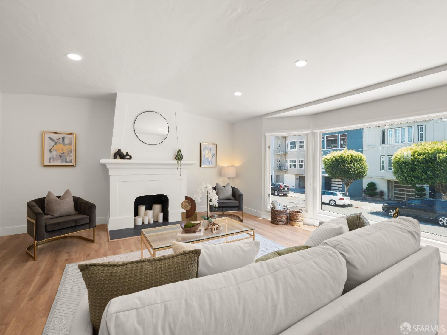 a living room with furniture fireplace and window