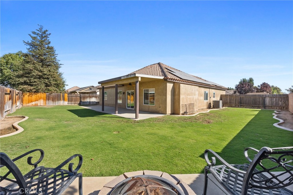 a view of a house with backyard porch and sitting area