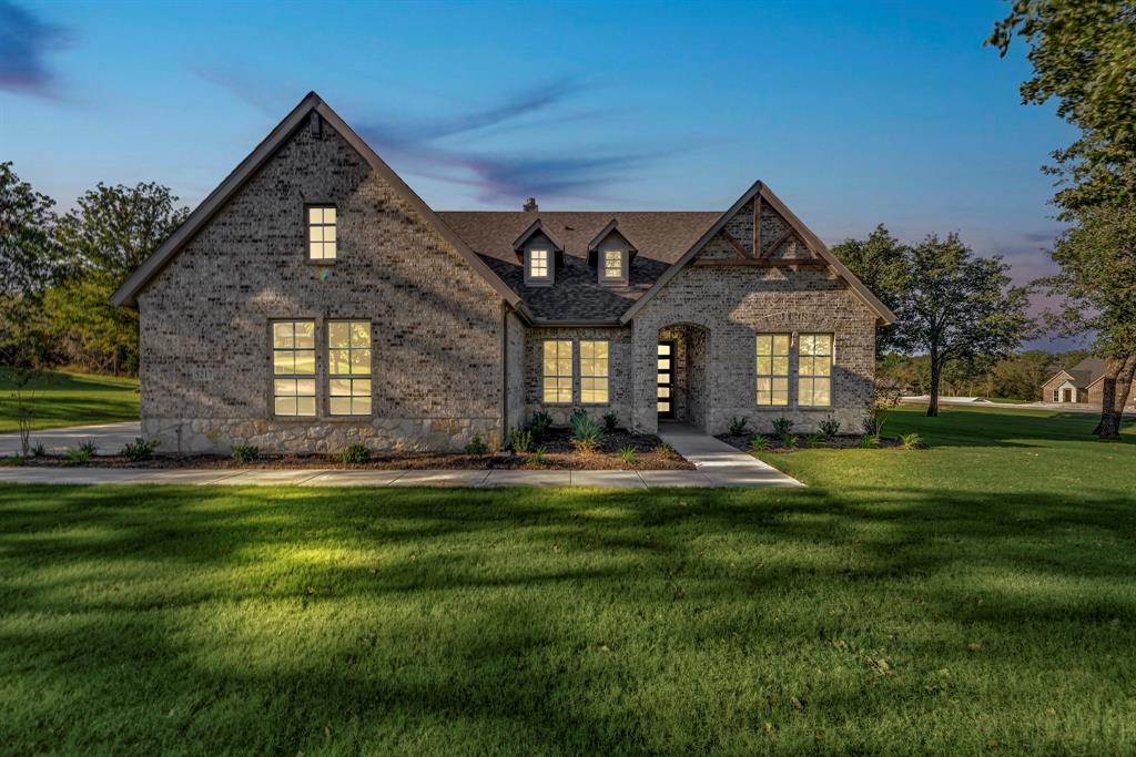 a front view of a house with a yard