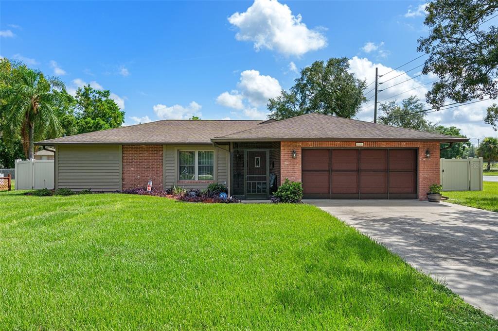 a front view of a house with a garden and yard