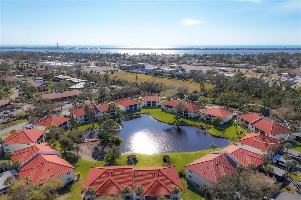 an aerial view of residential houses with outdoor space and lake view