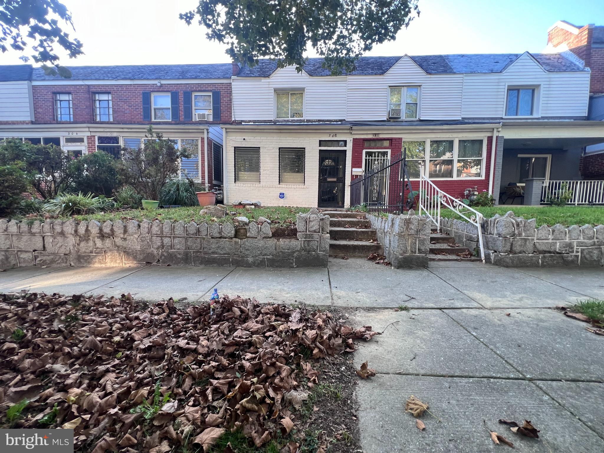 a front view of a house with a garden and pathway