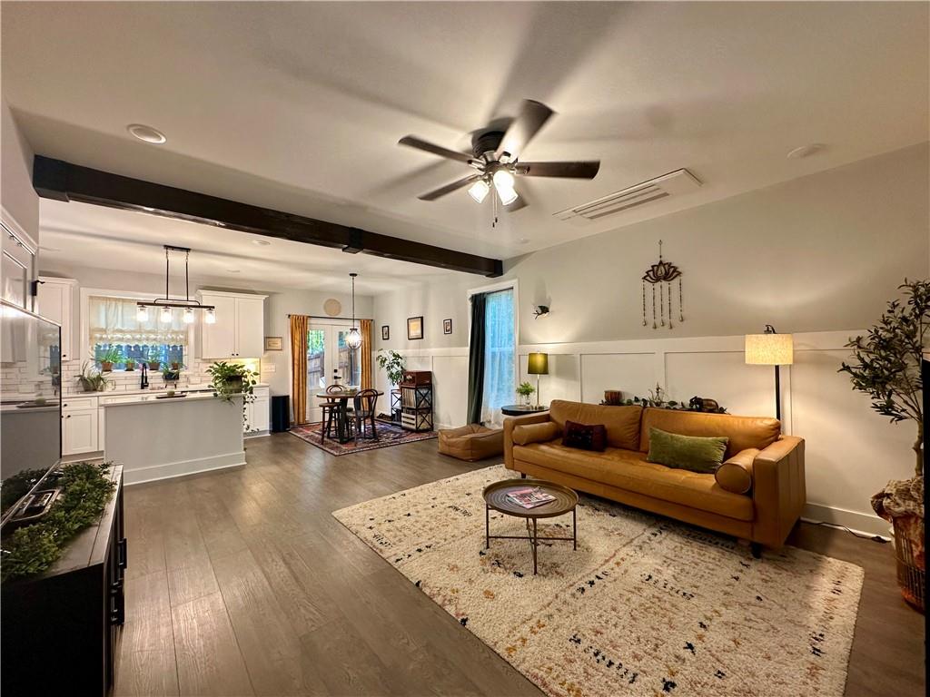 a living room with furniture and wooden floor