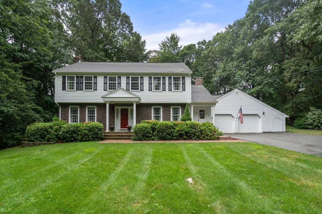 a front view of house with yard and green space