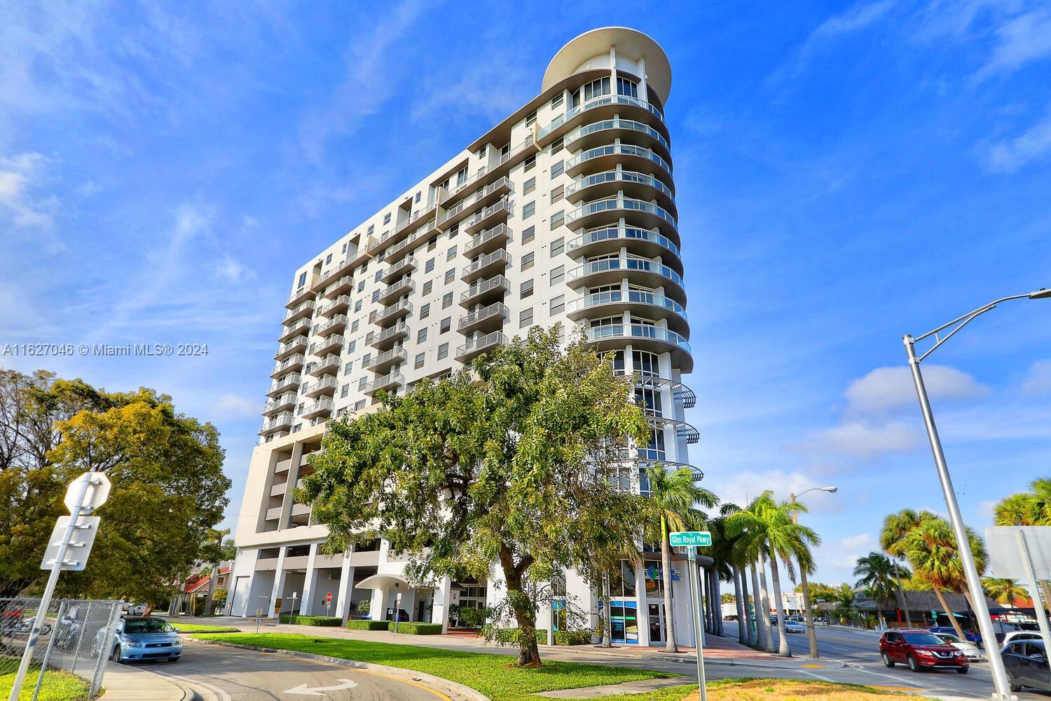 a view of a tall building next to a road