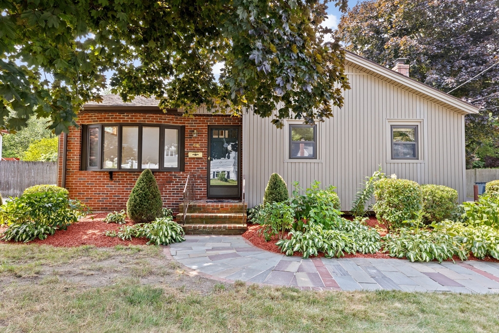 a front view of a house with garden