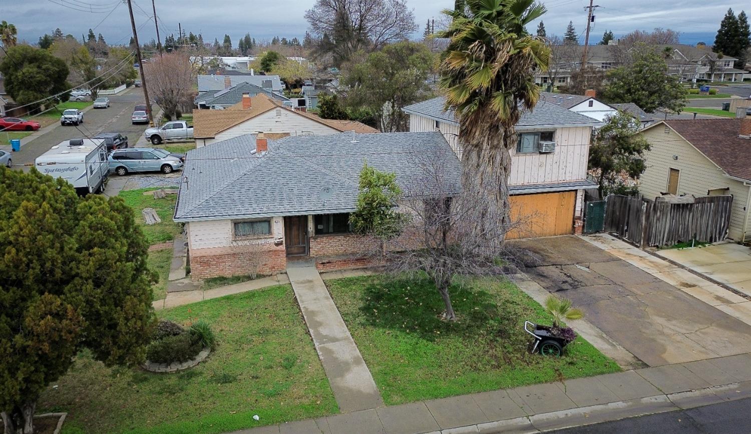 an aerial view of a house with a yard