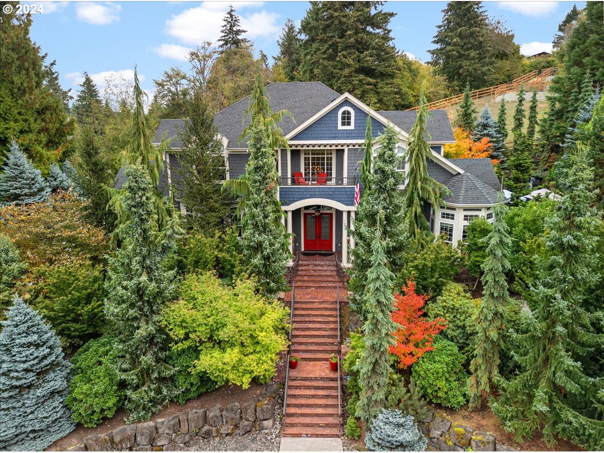 a front view of a house with a yard and fountain