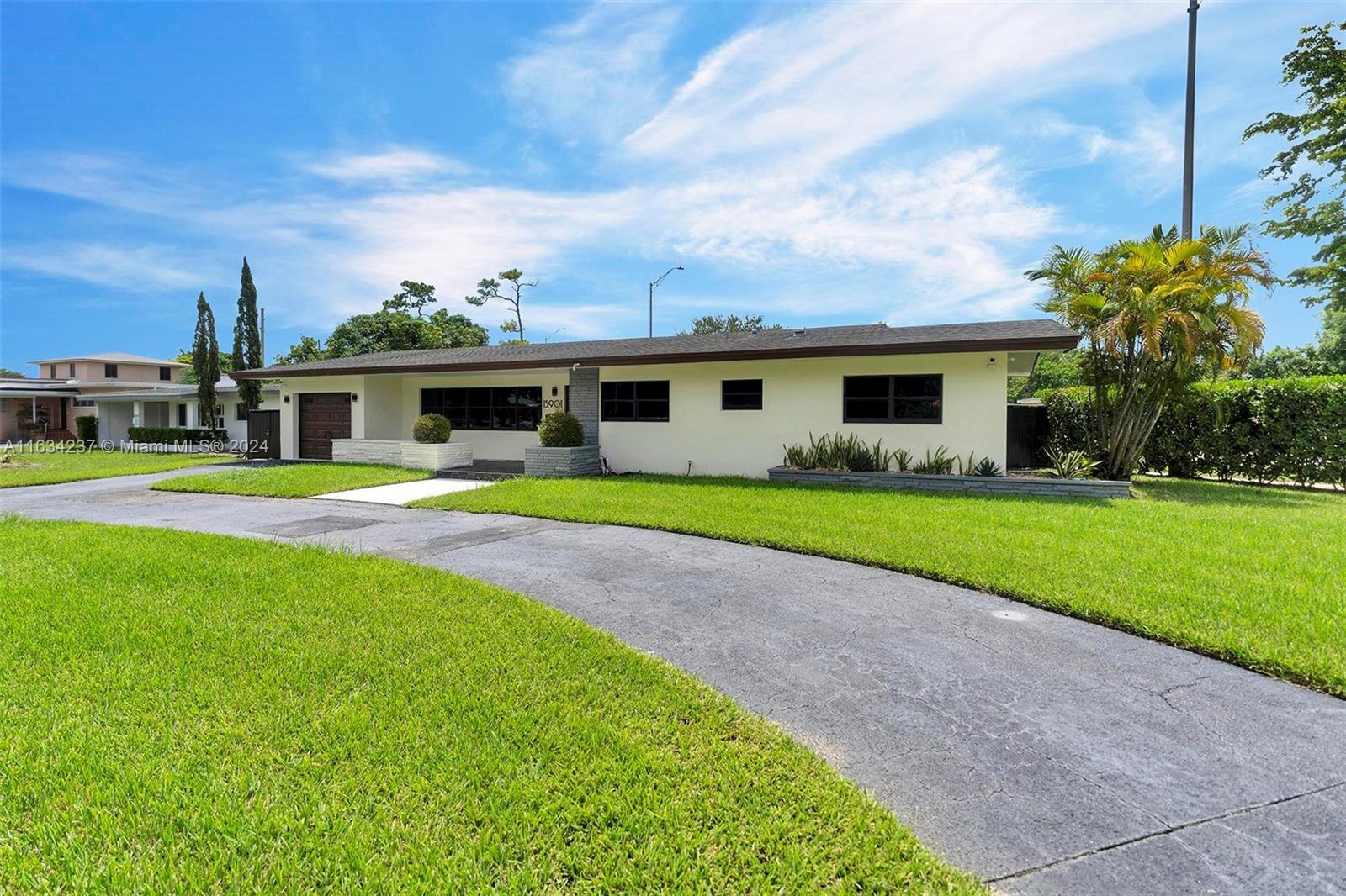 a front view of house with yard and green space