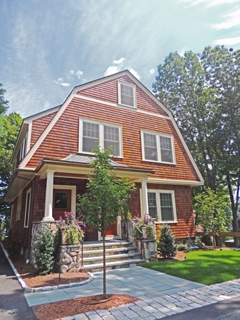 a front view of a house with garden