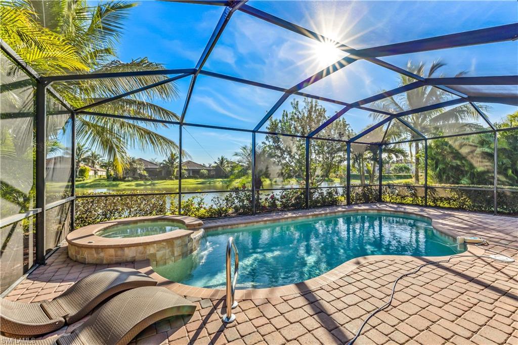 a view of a swimming pool with a patio and a yard