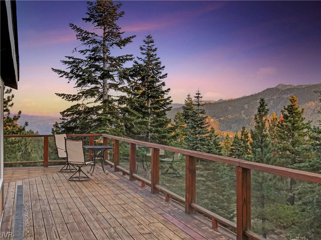 a view of a balcony with chairs and wooden floor