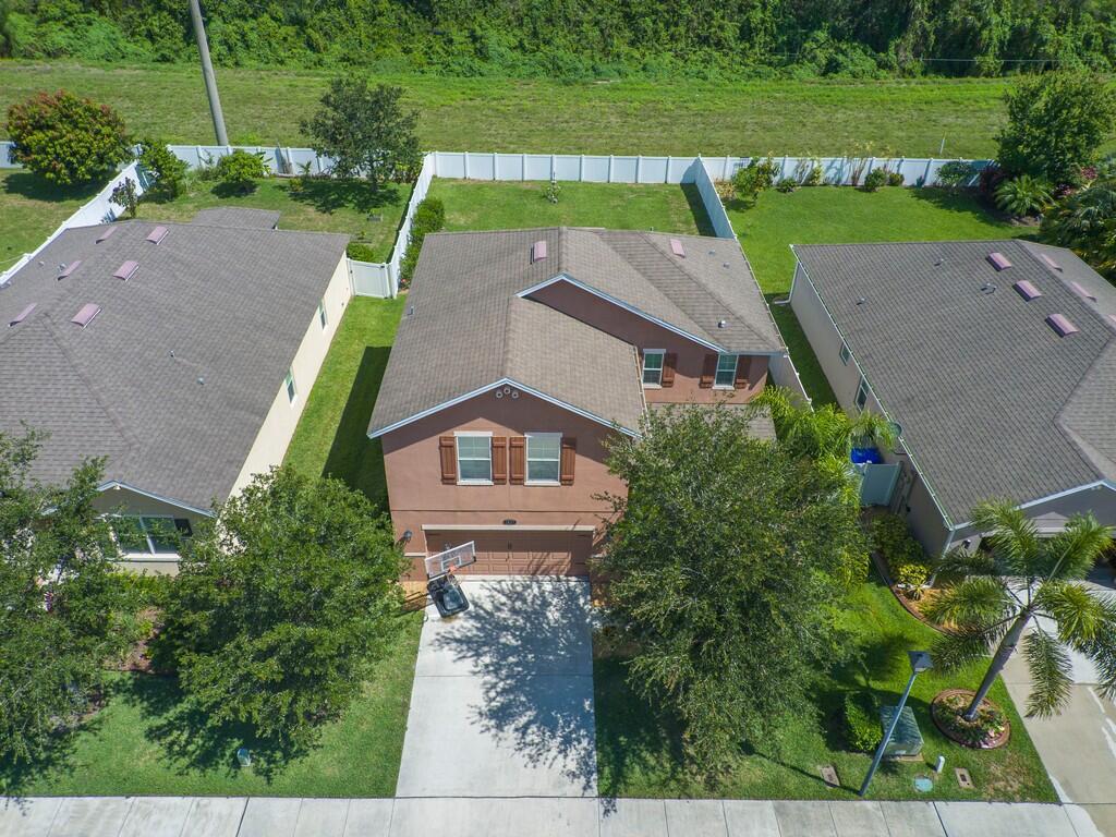 an aerial view of a house with a yard