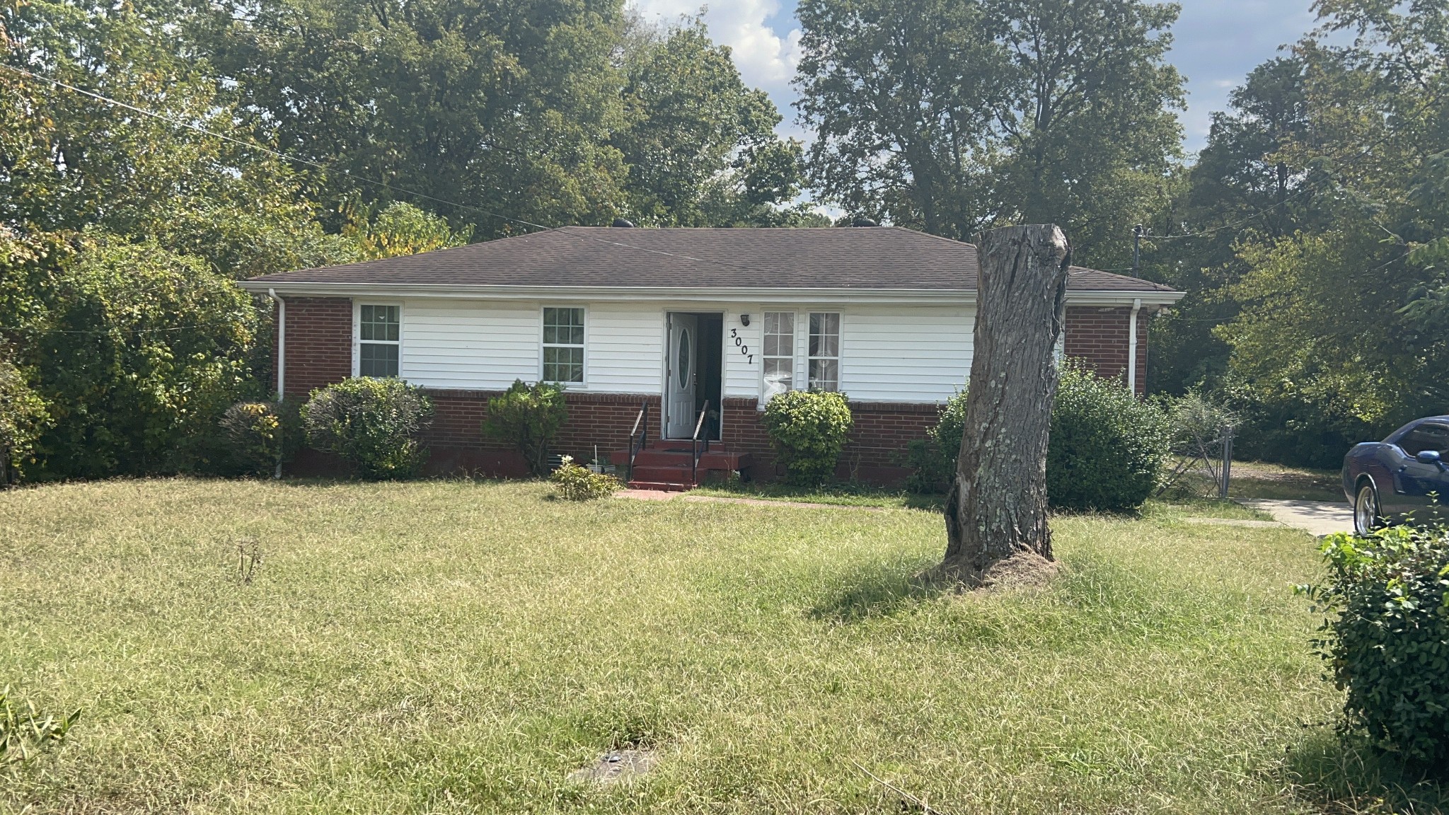 a view of a house with a yard and potted plants