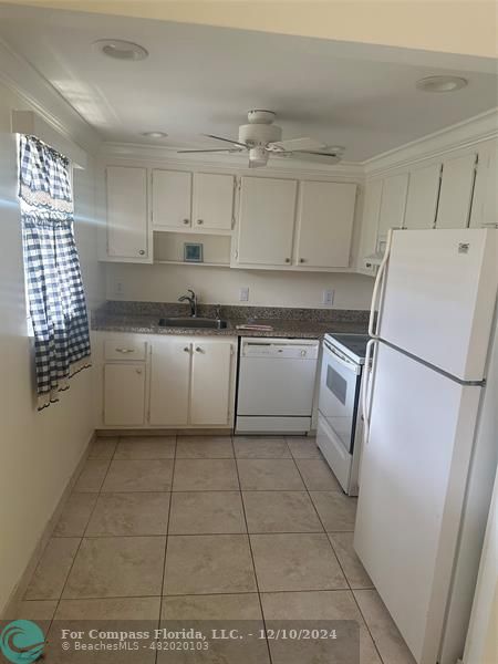 a kitchen with stainless steel appliances a refrigerator sink and cabinets