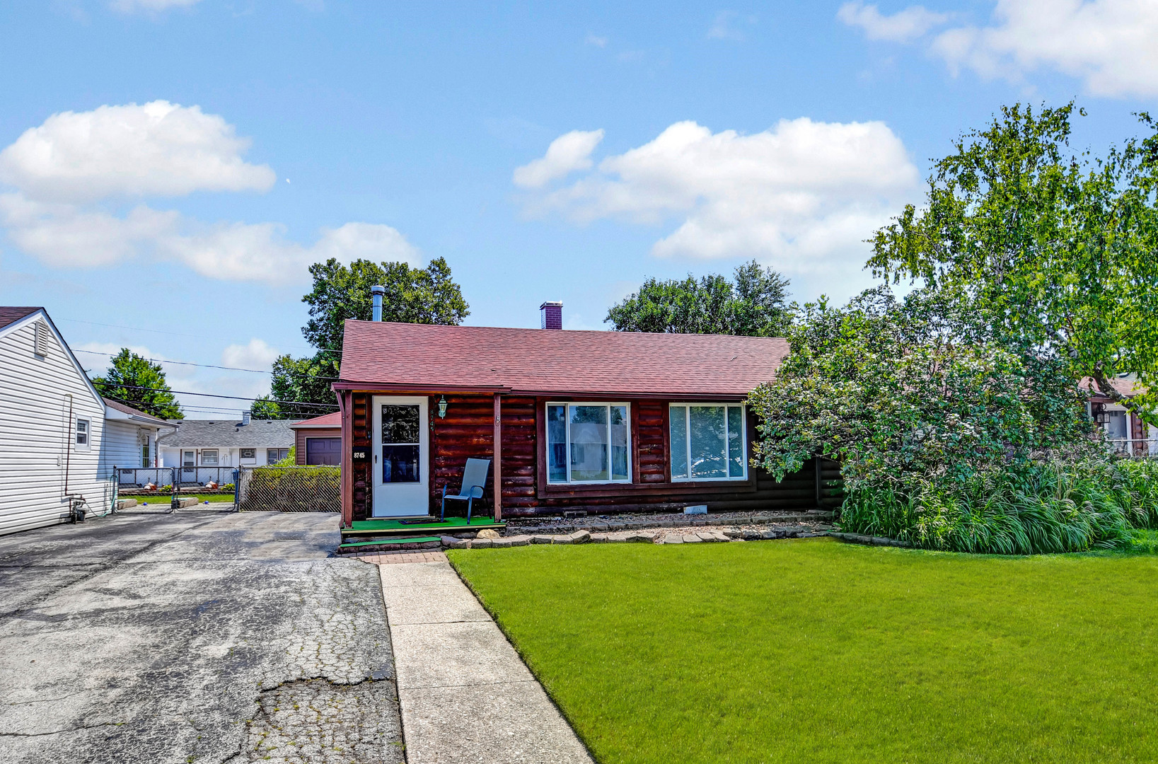 a view of a house with a backyard