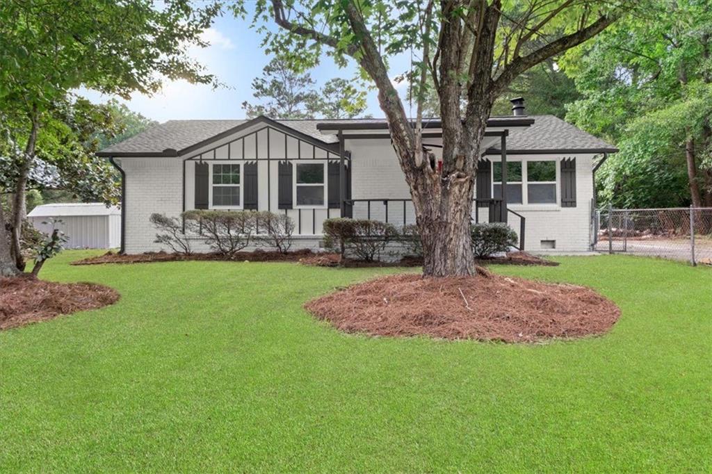 a front view of house with a garden and patio