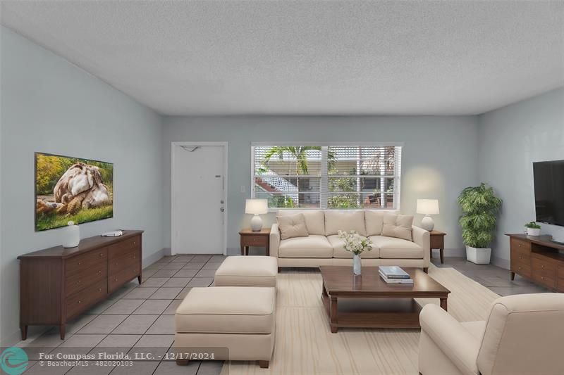 Spacious living room with great natural light and overlooking courtyard - photo is staged