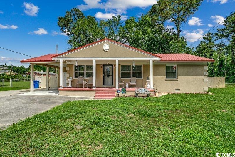 View of front of home with a front lawn and covere