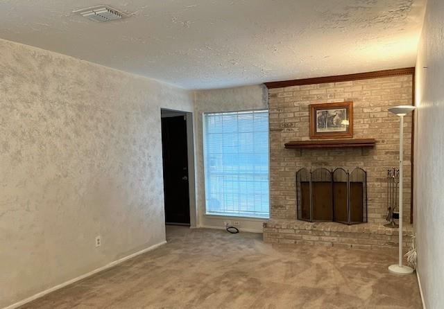 a view of a livingroom with a fireplace and cabinet