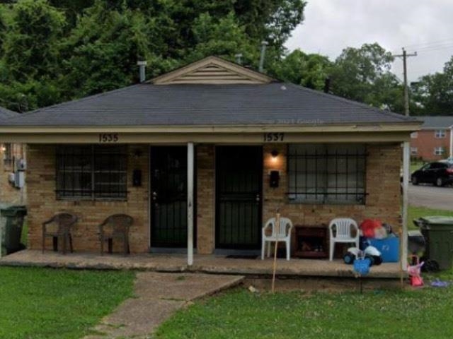 a front view of a house with a garden