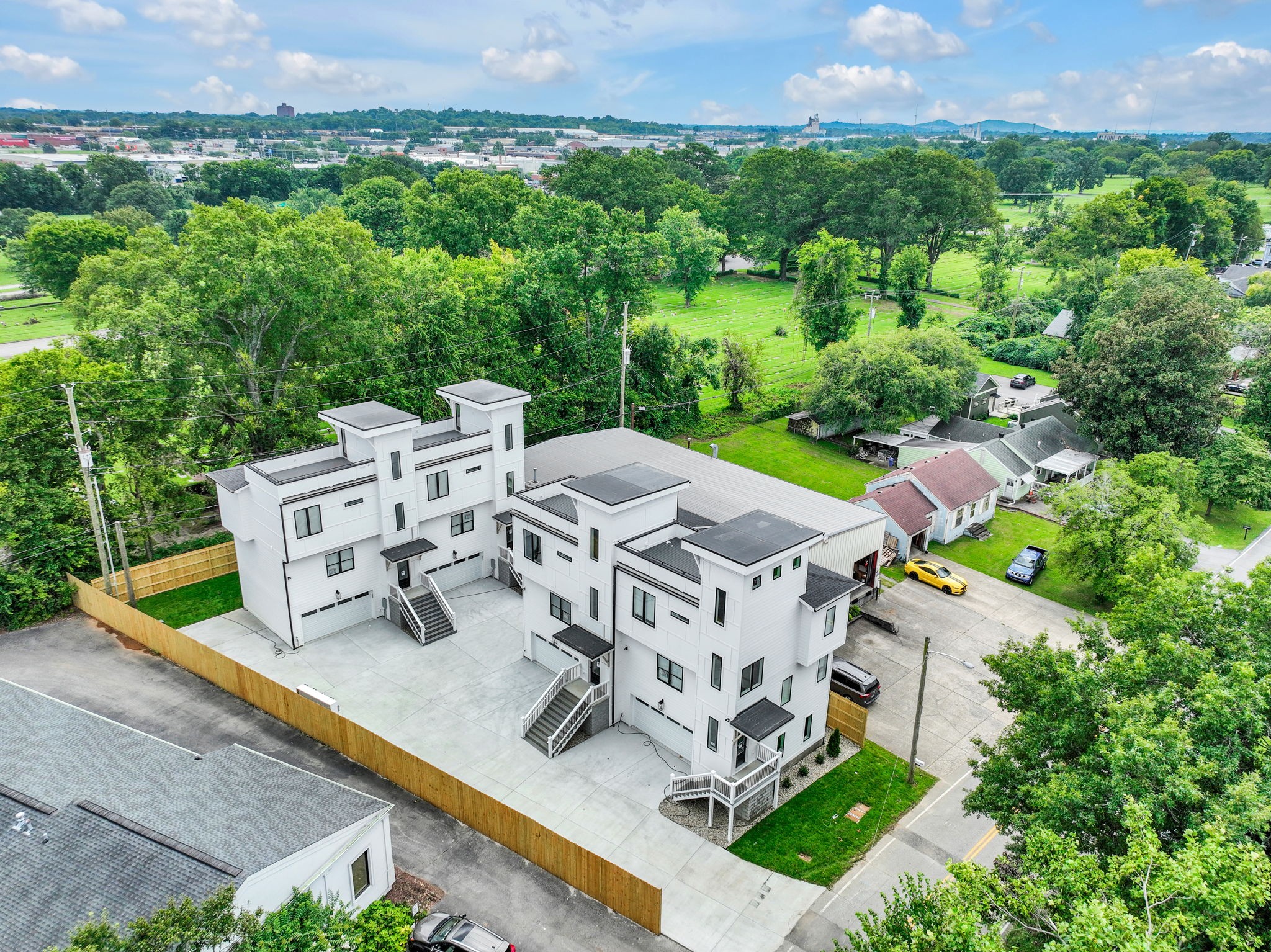 an aerial view of a house with garden space and street view