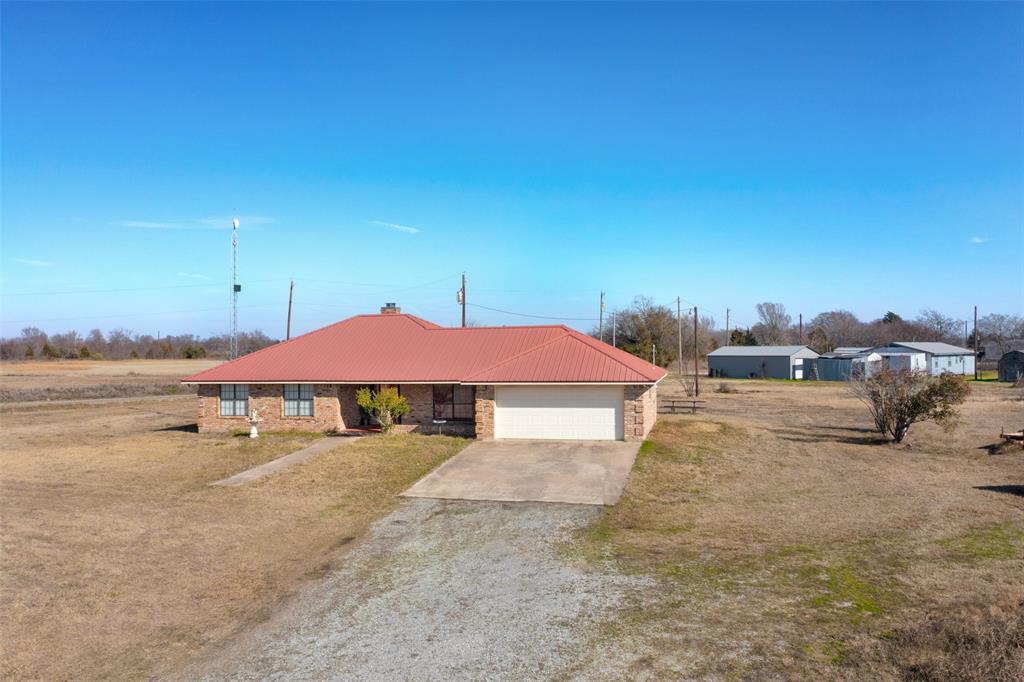 a view of a house with a yard and sitting area