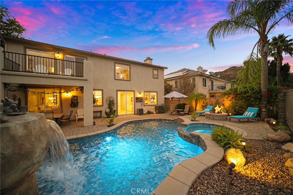 a view of a house with swimming pool and sitting area