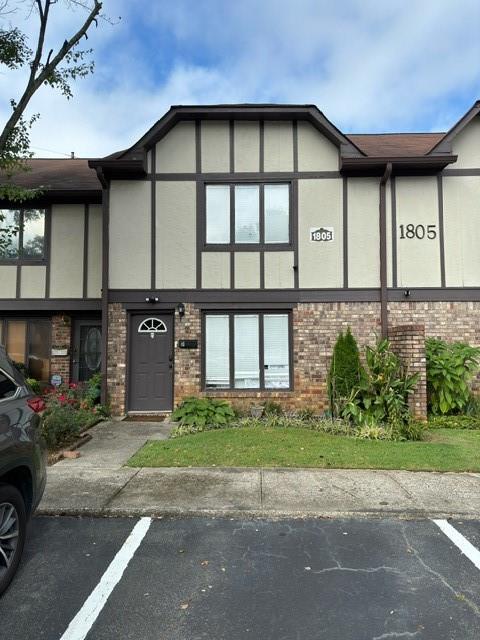 a front view of a house with a garden and garage