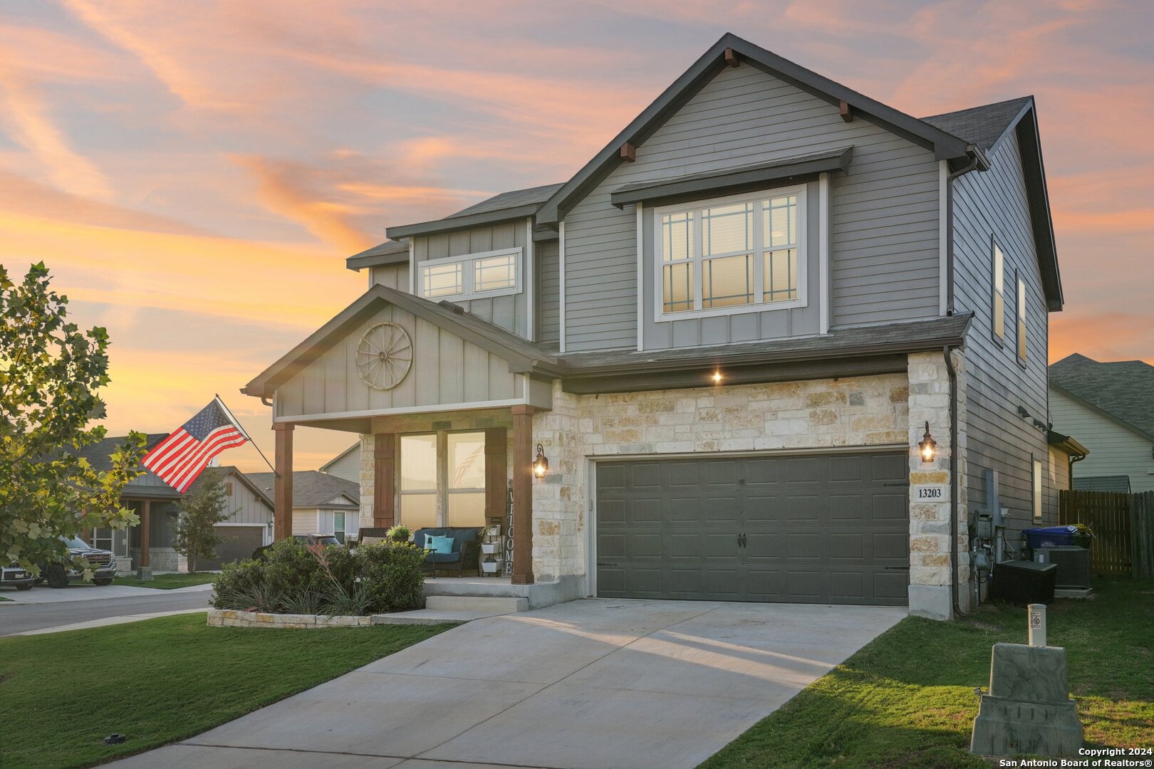 a front view of a house with a garden and garage