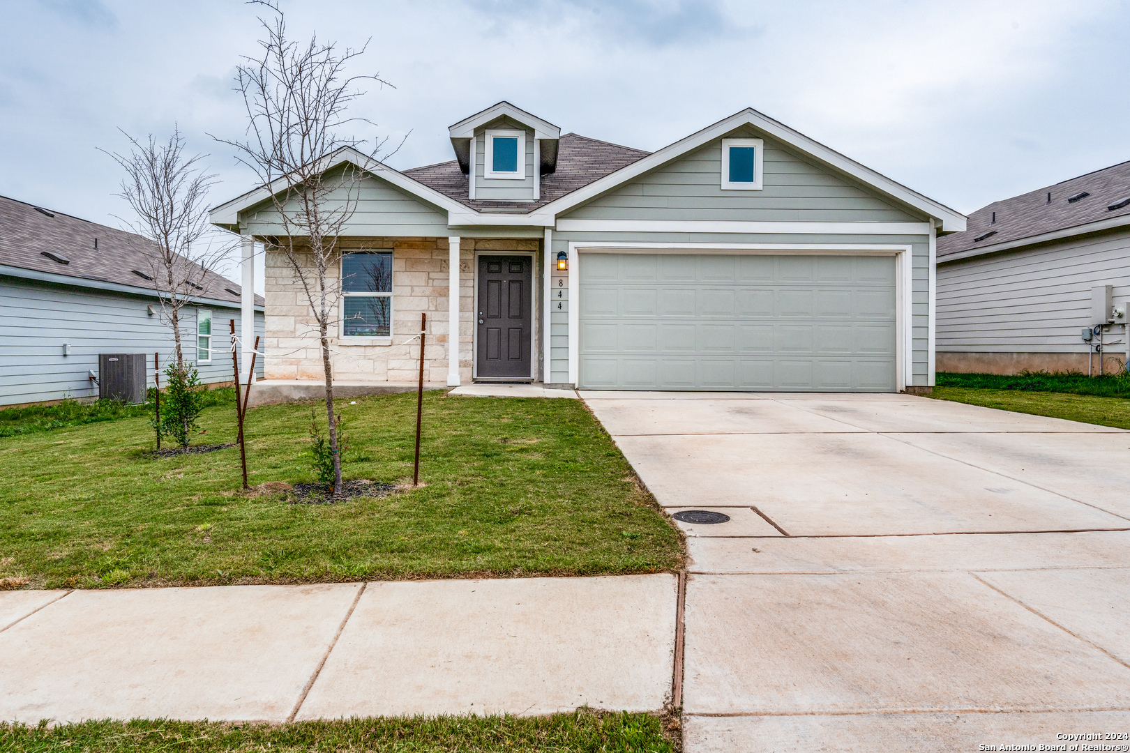 a front view of a house with a yard