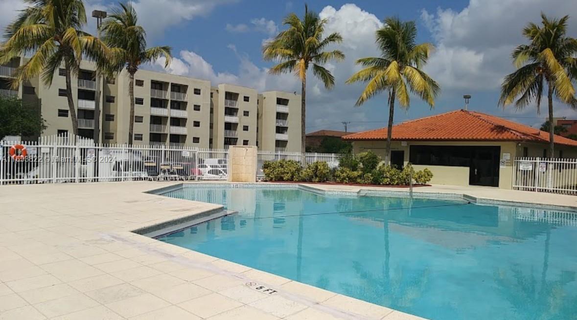 a swimming pool with outdoor seating and yard