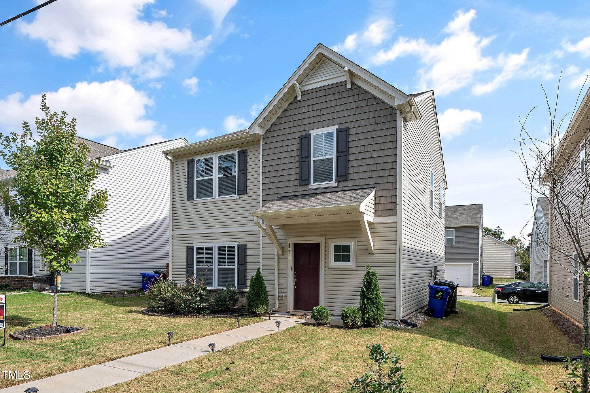 a front view of a house with a yard