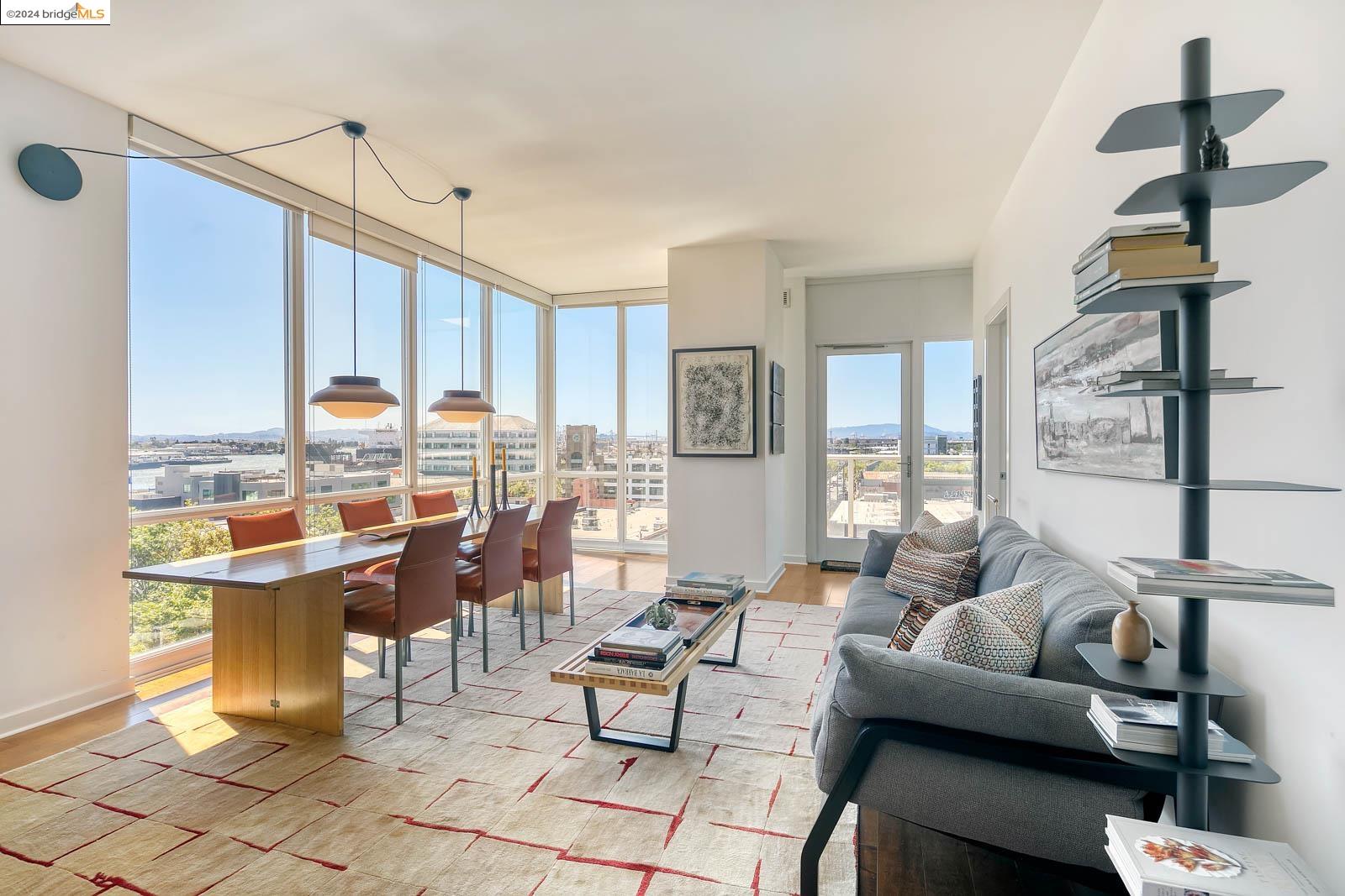 a living room with lots of furniture and a floor to ceiling window