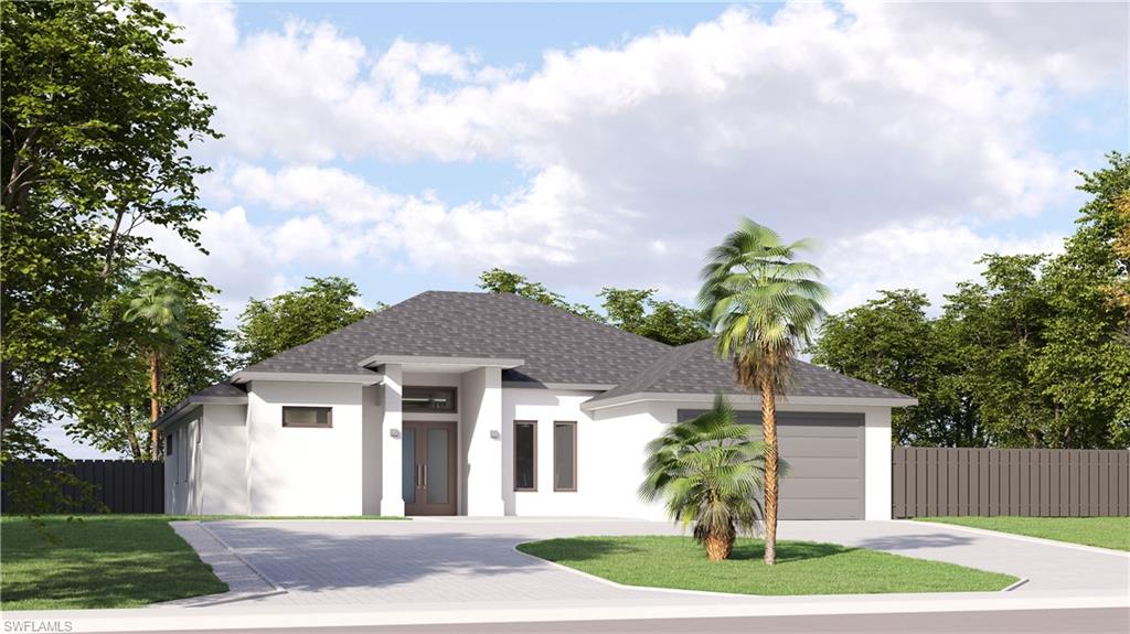 View of front of home featuring a garage and a front lawn