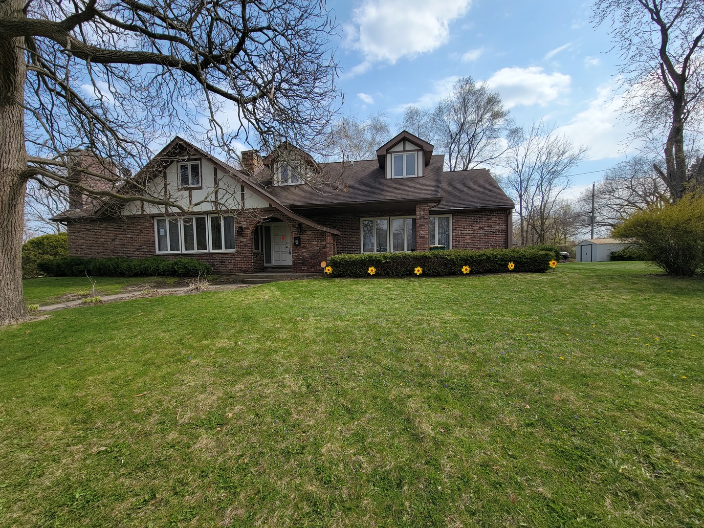 a view of a house with a big yard and large trees